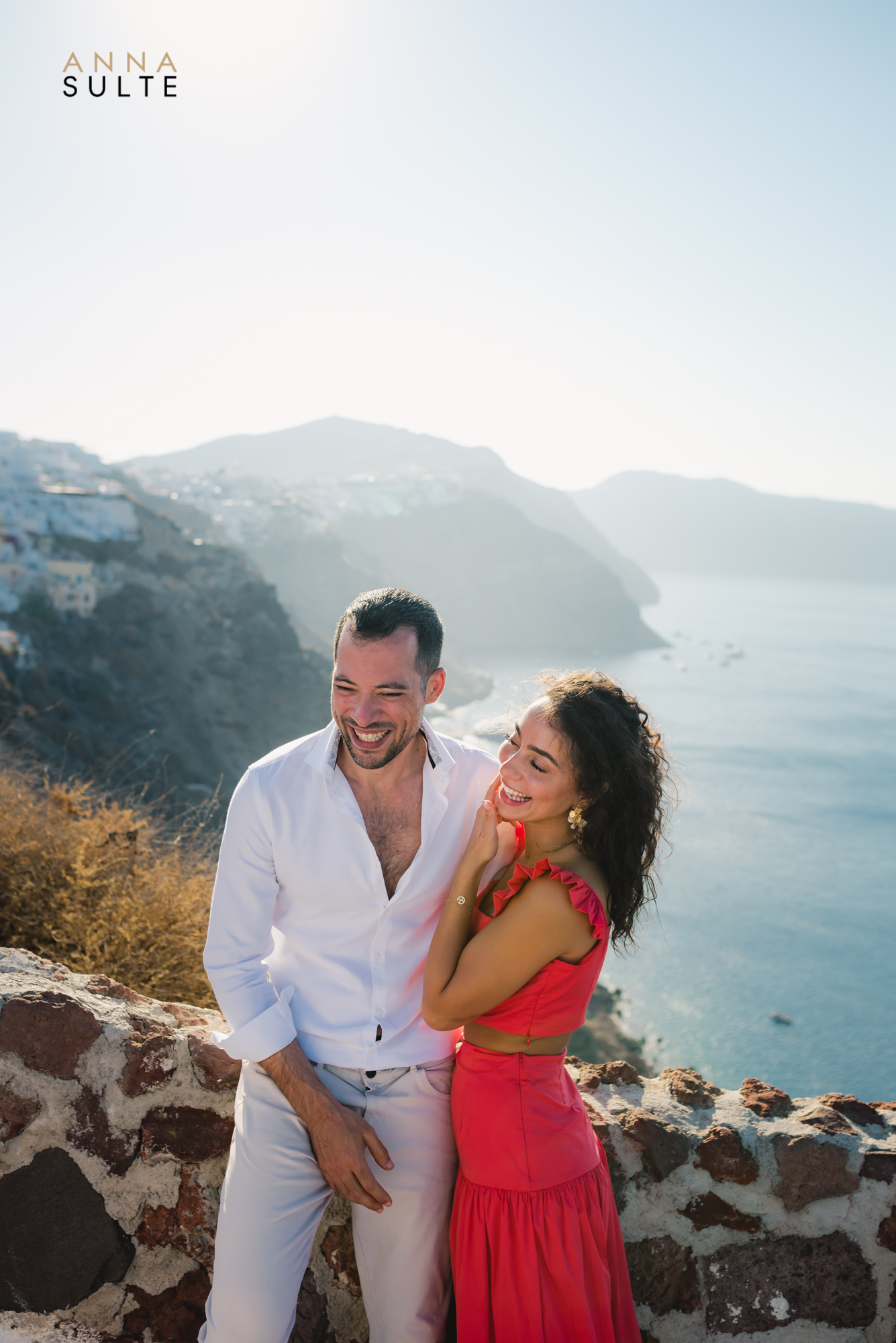 Laughing couple in Greece. Santorini honeymoon shoot.