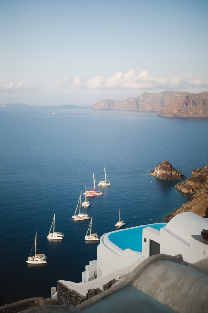 Santorini Caldera filled with different sailing boats.